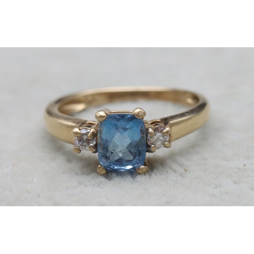 631 - A 9ct gold ring set with centre rectangular aquamarine flanked by 2 small diamonds, Size N, 2.1 gram... 