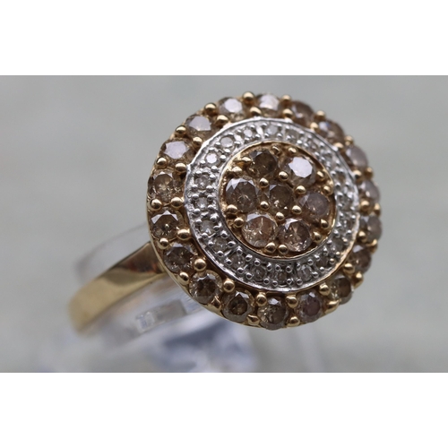 642 - A 9ct gold circular cluster ring with yellow and clear stones, Size O