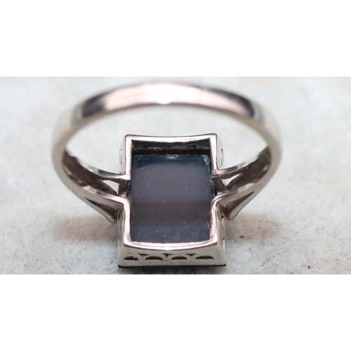 644 - A 9ct white gold ladies' rectangular shaped ring set with black stone inset with small diamonds, Siz... 