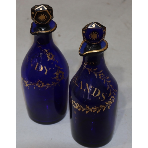 65 - A pair of Georgian Bristol blue glass small round bulbous thin necked spirit decanters with gilt dec... 