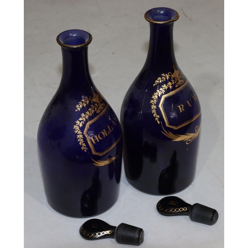 66 - A pair of Georgian round bulbous thin necked Bristol blue glass decanters with stoppers and gilt dec... 