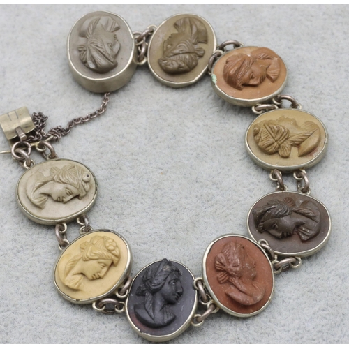 686 - A lava and Continental silver coloured metal bracelet mounted with 9 oval figureheads of ladies