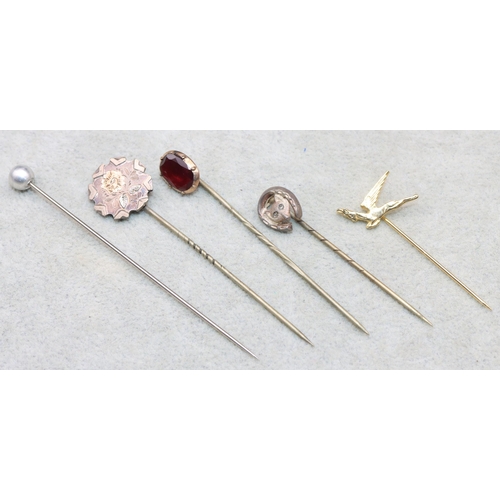 687 - A gold and silver stick pin mounted with garnet and 4 other stick pins (5)