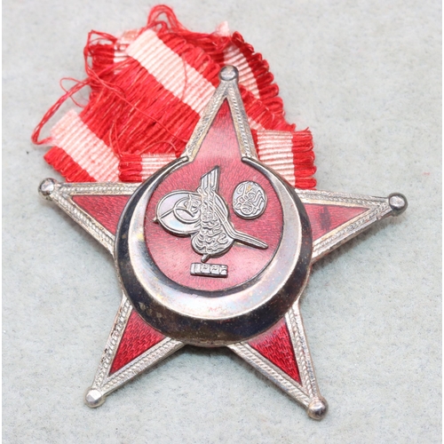 689 - An Ottoman War Medal (Turkish: Harp Madalyası),   silver coloured metal and red enamelled Star medal... 