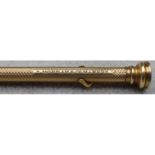 700 - S Morden & Co. gold propelling pencil with allover engine turned decoration and seal motif to top, 9... 