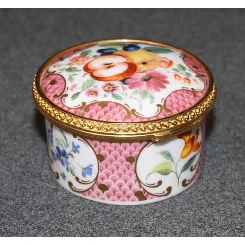 73 - A Royal Worcester Connoisseur Collection round pill box with hinged lid on white and pink ground wit... 