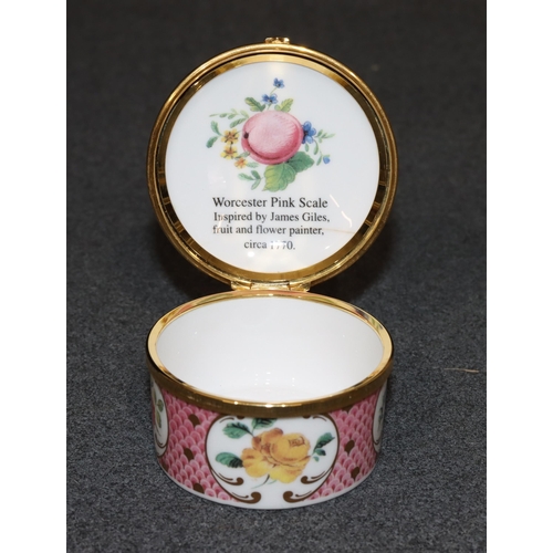 73 - A Royal Worcester Connoisseur Collection round pill box with hinged lid on white and pink ground wit... 