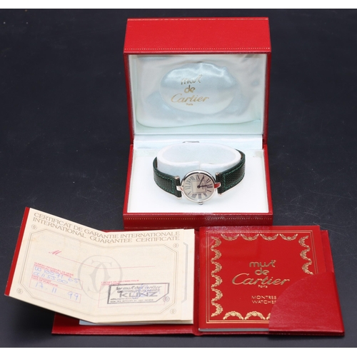 757 - A Must de Cartier ladies' silver circular wristwatch with Roman numerals and green leather strap bra... 