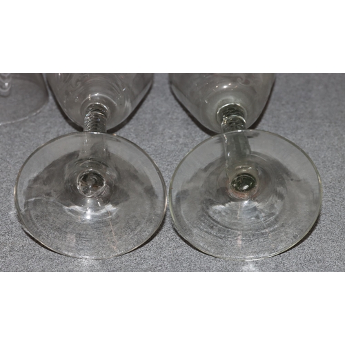 80 - A set of 14 19th/20th Century round trumpet shaped wine glasses with engraved scroll and monogram de... 