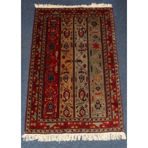 828 - A Persian rug on red and blue ground with 4 centre strips with hook and floral design, 131cm x 83cm