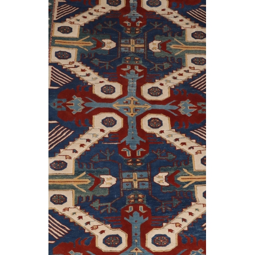 829 - A Persian rug on white, red and blue ground with allover medallions, 194cm x 143cm