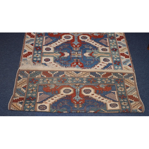 829 - A Persian rug on white, red and blue ground with allover medallions, 194cm x 143cm