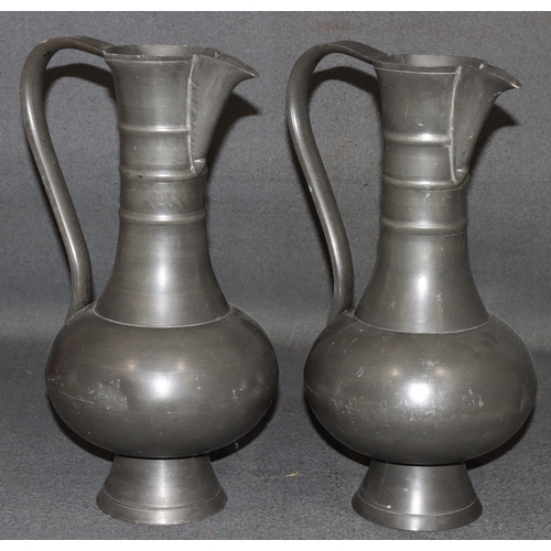 834 - A pair of Franciscus van den Bogaert pewter round bulbous thin necked jugs, both stamped to base, 37... 