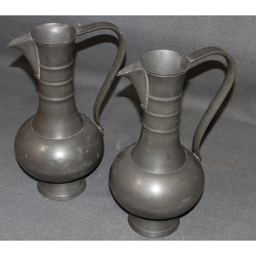 834 - A pair of Franciscus van den Bogaert pewter round bulbous thin necked jugs, both stamped to base, 37... 