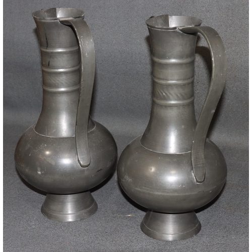 834 - A pair of Franciscus van den Bogaert pewter round bulbous thin necked jugs, both stamped to base, 37... 