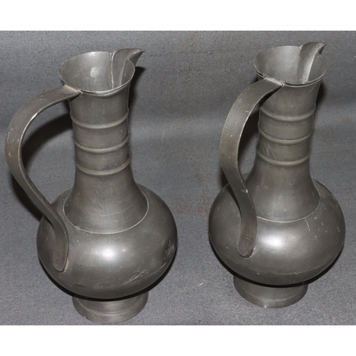 834 - A pair of Franciscus van den Bogaert pewter round bulbous thin necked jugs, both stamped to base, 37... 