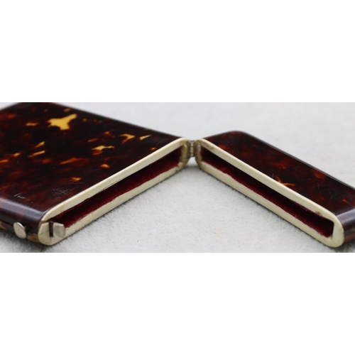 838 - A 19th Century dark tortoiseshell card case with hinged top, 11cm high, 8.3cm wide