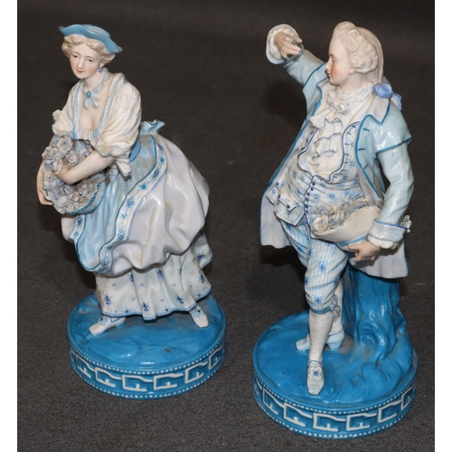 86 - A pair of Paris porcelain figures of standing gentleman and lady on white and blue ground holding ba... 