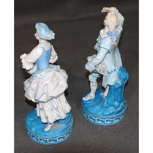 86 - A pair of Paris porcelain figures of standing gentleman and lady on white and blue ground holding ba... 