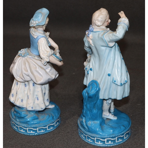 86 - A pair of Paris porcelain figures of standing gentleman and lady on white and blue ground holding ba... 