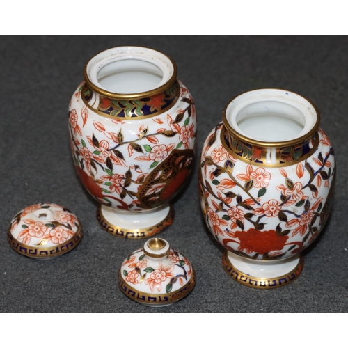 91 - A pair of Derby Imari pattern round bulbous lidded pots (1 finial missing), 13cm high