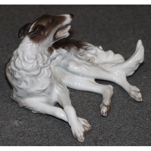 95 - A Rosenthal china figure of a resting dog on white and brown ground, 14cm wide, 9.5cm high