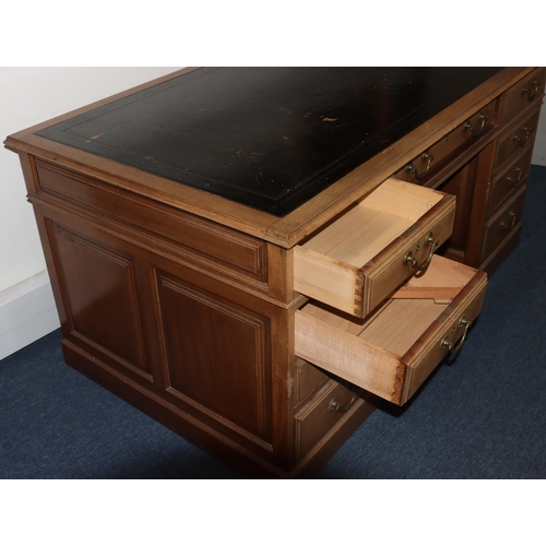 991 - A mahogany kneehole pedestal desk having black leather inset top, centre drawer flanked by 8 short g... 