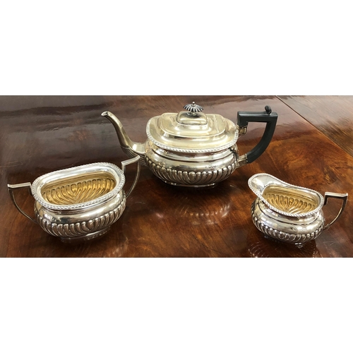 470 - An Edward VII silver rectangular bulbous shaped tea service with half embossed reeded decoration, co... 