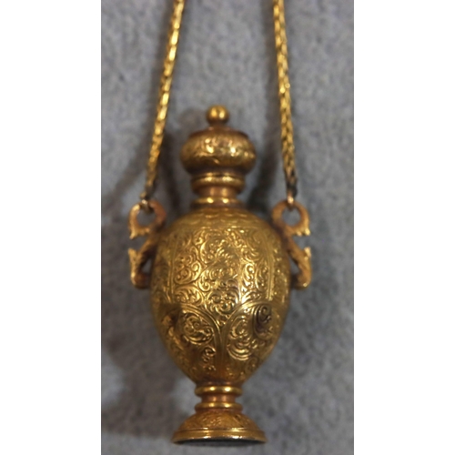 748 - A gold pendant snuff bottle/seal in the form of an urn with hinged lid with allover engraved scroll ... 