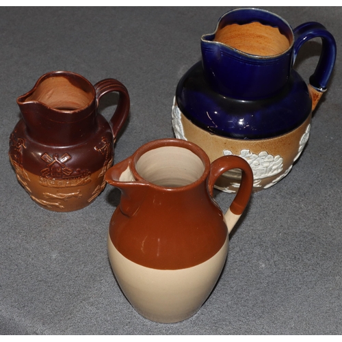 108 - A Royal Doulton glazed earthenware round bulbous shaped hunting jug with raised windmill figure and ... 