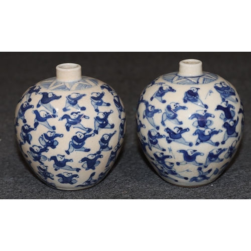 111 - A pair of Chinese miniature round bulbous thin necked vases on blue and white ground with allover fi... 