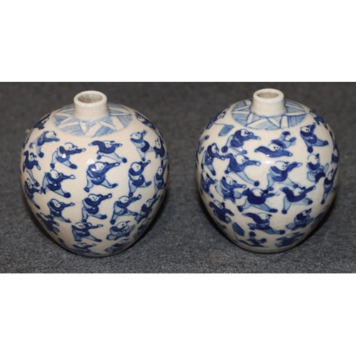 111 - A pair of Chinese miniature round bulbous thin necked vases on blue and white ground with allover fi... 