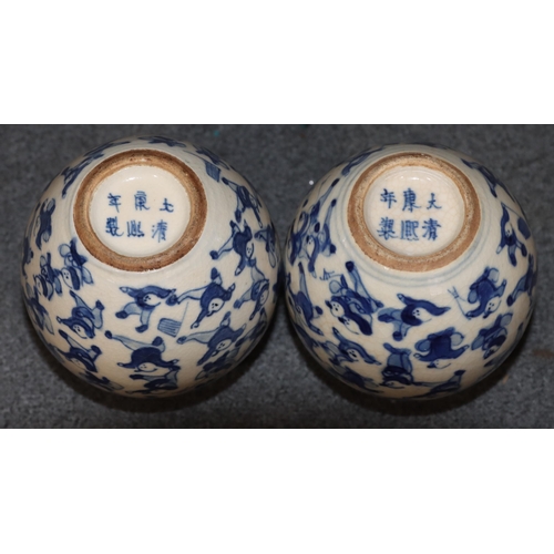 111 - A pair of Chinese miniature round bulbous thin necked vases on blue and white ground with allover fi... 