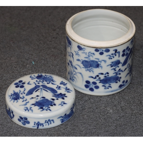 112 - A 19th Century Chinese cylindrical lidded pot on blue and white ground with butterfly, floral and le... 