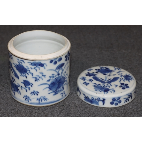 112 - A 19th Century Chinese cylindrical lidded pot on blue and white ground with butterfly, floral and le... 