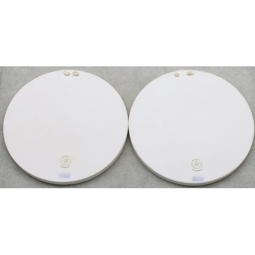 122 - A pair of Royal Copenhagen Parian circular plaques with raised Angel and Cupid motifs, 15.2cm diamet... 