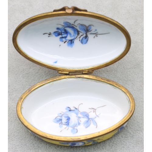 125 - A Sevres oval snuff box on yellow and blue ground with floral and leaf decoration, 7.7cm wide