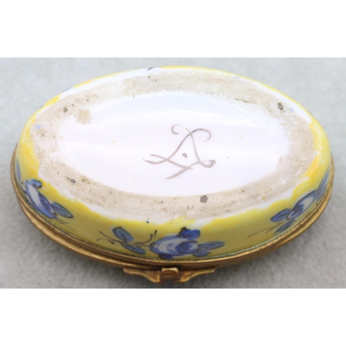 125 - A Sevres oval snuff box on yellow and blue ground with floral and leaf decoration, 7.7cm wide