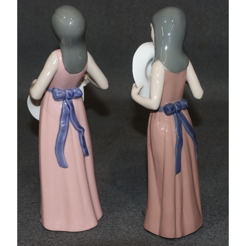 132 - 2 Lladro figures of standing young ladies holding hats, wearing pink dresses, largest 25.5cm high (2... 