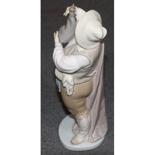 134 - A Lladro figure of a standing gentleman holding a water bottle, 21cm high