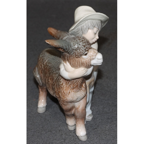 135 - A Lladro group of a young Mexican boy hugging a donkey, 20.5cm high