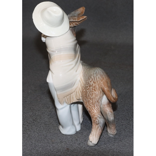 135 - A Lladro group of a young Mexican boy hugging a donkey, 20.5cm high