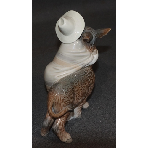 135 - A Lladro group of a young Mexican boy hugging a donkey, 20.5cm high