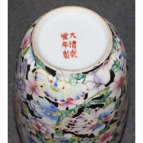 144 - An Oriental round bulbous thin necked trumpet shaped vase on multi-coloured floral, leaf ground, 20c... 