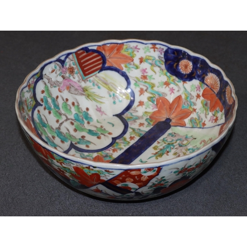 149 - An Imari round scallop shaped bowl on white ground with multi-coloured figure, leaf, branch and scro... 