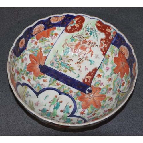 149 - An Imari round scallop shaped bowl on white ground with multi-coloured figure, leaf, branch and scro... 