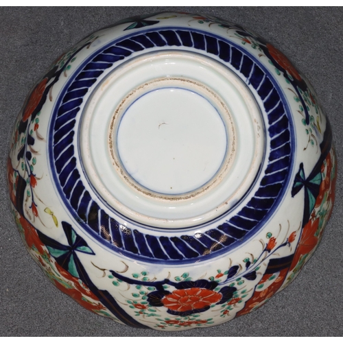 149 - An Imari round scallop shaped bowl on white ground with multi-coloured figure, leaf, branch and scro... 