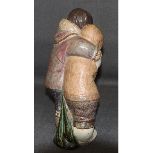 150 - A Lladro large glazed earthenware group of Eskimos cuddling, 38cm high