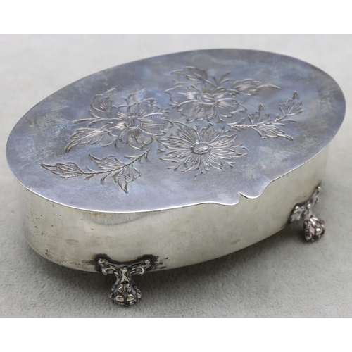 328 - A Continental oval silver coloured metal trinket box with hinged lid with floral and leaf decoration... 