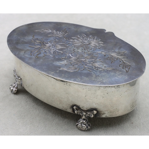 328 - A Continental oval silver coloured metal trinket box with hinged lid with floral and leaf decoration... 